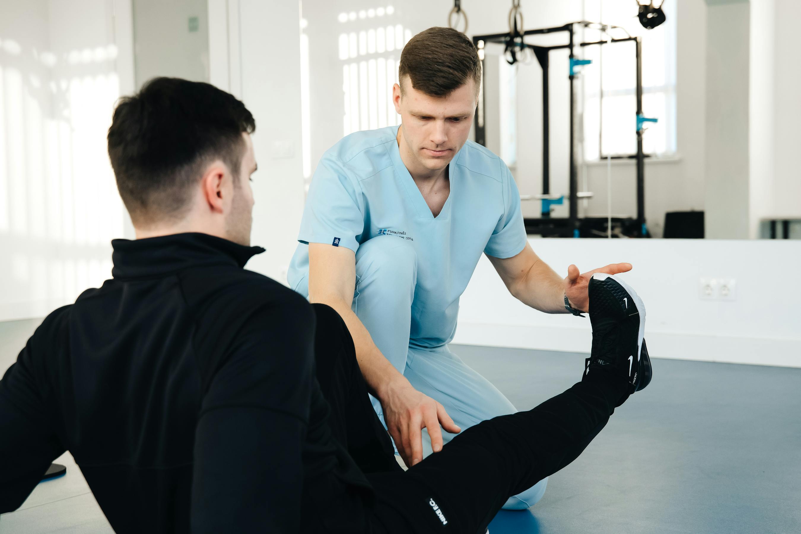 Physiotherapist assisting a patient with leg rehabilitation